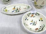 three dishes and cups on a table with a white table cloth