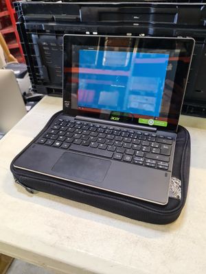 a laptop computer sitting on top of a table