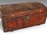 an old leather trunk with ornate carvings and brass hardware