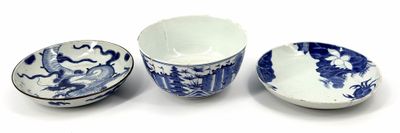 three blue and white bowls and a bowl on a white surface
