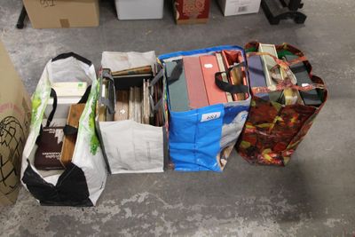 many bags of books on the floor next to each other