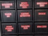 many black boxes with red numbers on them in a room