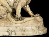 a statue of a lion on a marble base