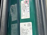 a close up of a green bus door with a sign on it
