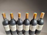 six bottles of wine are lined up in a row
