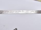 a close up of a metal object with writing on it