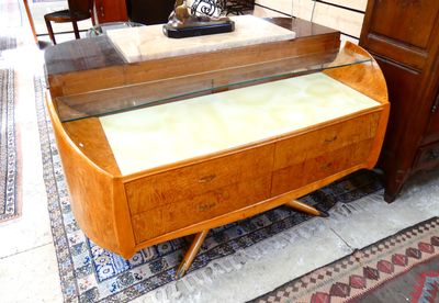 a glass display case on a wooden table in a living room