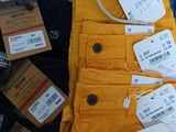 a pile of clothes with tags on them on a table