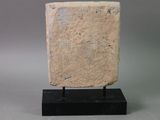 an image of a stone block on a black stand on a gray background