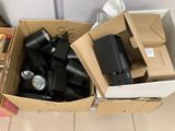 a cardboard box full of electronic equipment on the floor