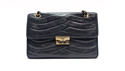 a black handbag with gold hardware on the handle