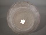 a glass bowl with a piece of paper sticking out of it