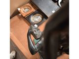 a statue of a man sitting on a desk next to a clock