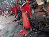 rows of red and black gym equipment in a large gym