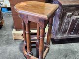 a wooden stool that is sitting in the middle of a room