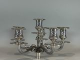 a silver candelier that has five candles on it