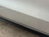 a car that has been painted white with a black stripe on the side