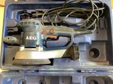 a small electric sander in a plastic case on a table