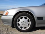 a silver car that is parked on the side of the road