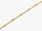 a gold bracelet with multi colored stones on a white background