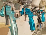 two airbrushes that are attached to a wall in a room