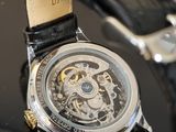a close up of a watch with a black strap