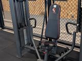 a gym equipment set up in front of a chain link fence