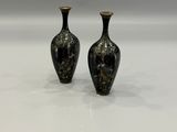 two vases that are sitting on a white surface