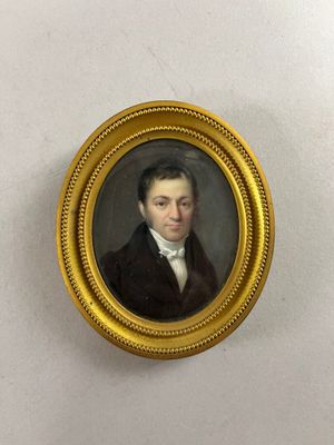 portrait of a man in a black coat and white shirt