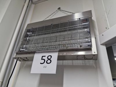 a sign hanging from the ceiling of a kitchen