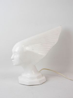 an image of a white sculpture of a woman ' s head with wings on it
