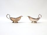 pair of silver plated sauce boats with handles