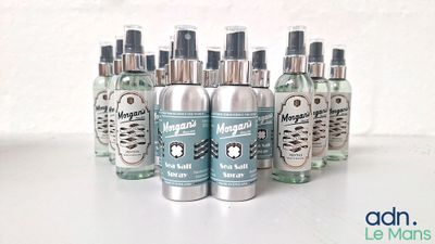 several bottles of perfume sitting on top of a white table