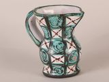 a blue and white vase with a rose design on it