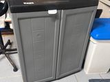 a black and gray cabinet in the middle of a room