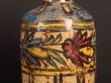 a vase with a floral design on it sitting on a table