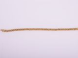 a gold bracelet on a white background