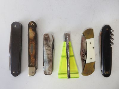several different types of knives are lined up on a white surface