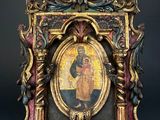 an old picture frame with a picture of a man holding a cross