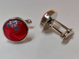 pair of red and blue cufflinks on white surface