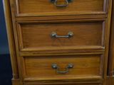 a wooden chest of drawers with three drawers on top of it
