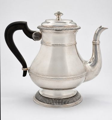an antique silver teapot with a black handle on a white background