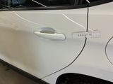 a white car with a sticker on the side of it ' s door