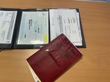 a passport and a book sitting on a desk
