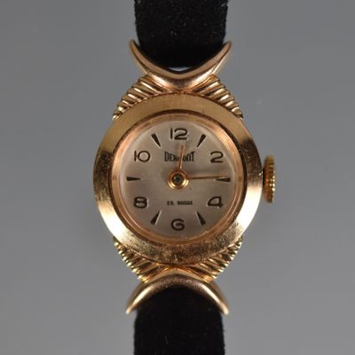 an image of a close up of a wrist watch on a black strap
