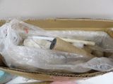 a cardboard box filled with items that include toothbrushes and toothpaste