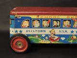 a toy bus that is sitting on a black surface