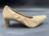a close up of a pair of beige shoes on a gray surface