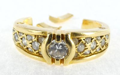 a close up of a gold ring with diamonds on it