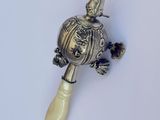 a small silver object on a white surface